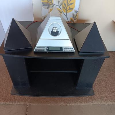 Cool Radio Shack light up am/FM CD / Cassette Clock radio with speakers on a Black media cabinet stand.