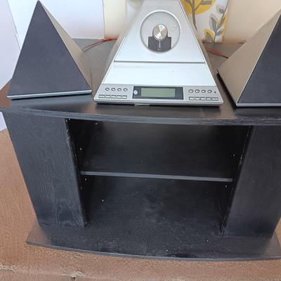 Cool Radio Shack light up am/FM CD / Cassette Clock radio with speakers on a Black media cabinet stand.