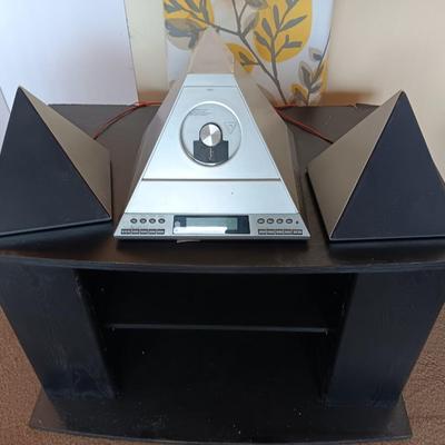 Cool Radio Shack light up am/FM CD / Cassette Clock radio with speakers on a Black media cabinet stand.