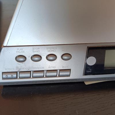Cool Radio Shack light up am/FM CD / Cassette Clock radio with speakers on a Black media cabinet stand.
