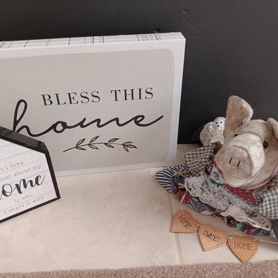 Two Home wall art pictures and a welcome pig
