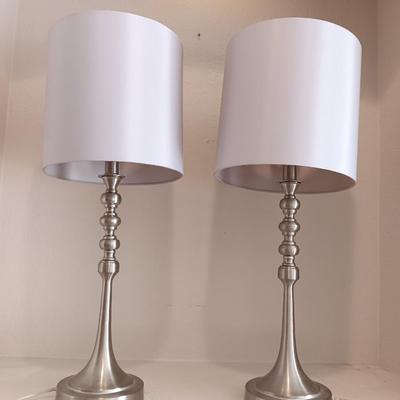 Two matching silver colored electric accent table lamps