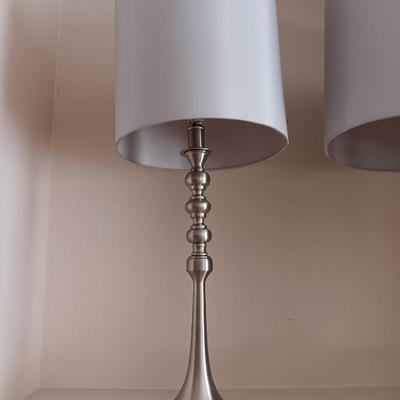 Two matching silver colored electric accent table lamps