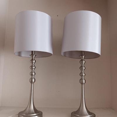 Two matching silver colored electric accent table lamps