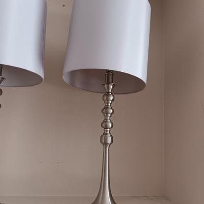 Two matching silver colored electric accent table lamps