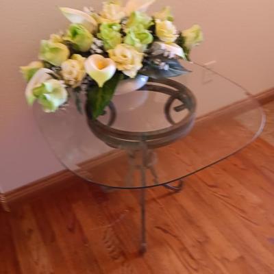 Metal base glass topped end / accent table with faux floral arrangement in a Decorative pot