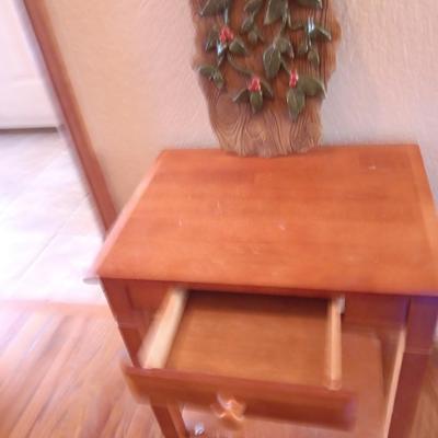 Small wooden accent table with drawer and unique pottery birds in a nest artwork