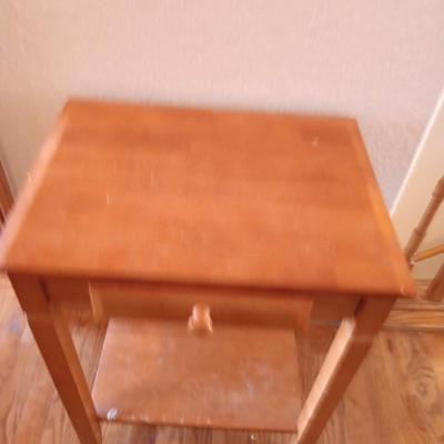 Small wooden accent table with drawer and unique pottery birds in a nest artwork