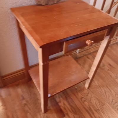 Small wooden accent table with drawer and unique pottery birds in a nest artwork