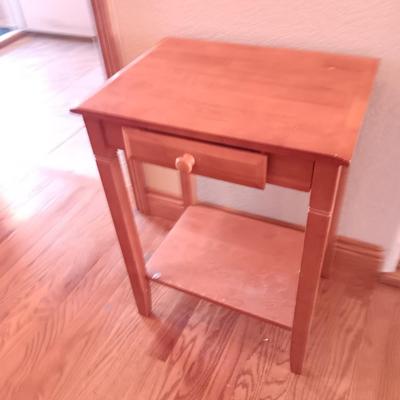 Small wooden accent table with drawer and unique pottery birds in a nest artwork