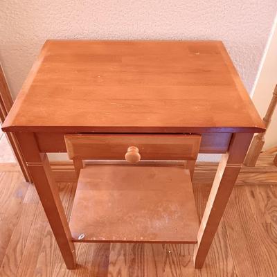 Small wooden accent table with drawer and unique pottery birds in a nest artwork