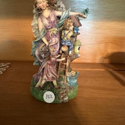 Guardian Angel with Children music box figurine. Plays “Welcome To My World “