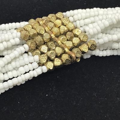 Beautiful White Glass seed bead with Gold Accent throughout. Pretty