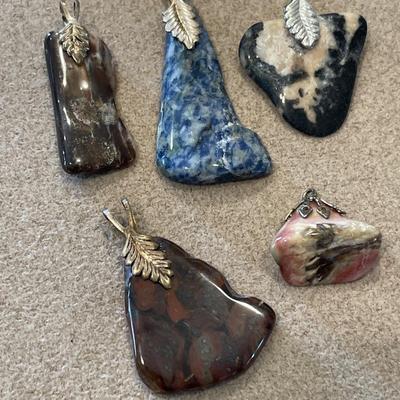 5 polished stone pendants