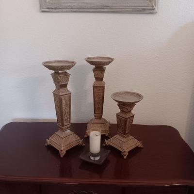 3 MATCHING CANDLE HOLDERS AND A SMALL CANDLE IN GLASS