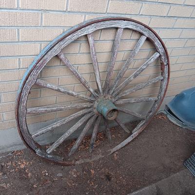 ANTIQUE WAGON WHEEL WITH WOOD SPOKES AND IRON RIM AND HUB
