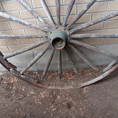 ANTIQUE WAGON WHEEL WITH WOOD SPOKES AND IRON RIM AND HUB