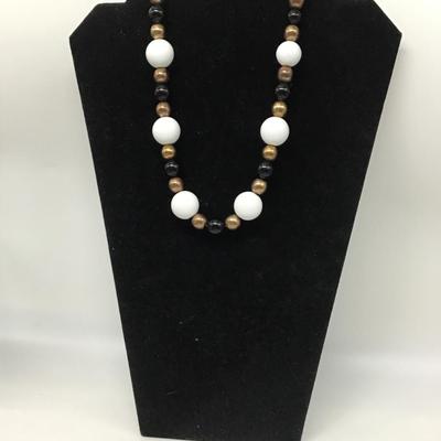 Gold toned, white, and black beaded necklace