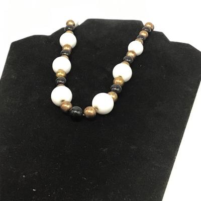 Gold toned, white, and black beaded necklace