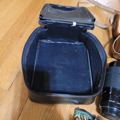 Two vintage cameras with cases and lenses and cases