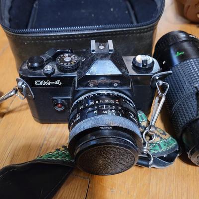 Two vintage cameras with cases and lenses and cases