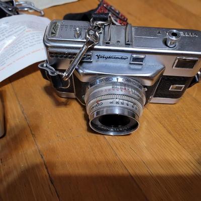 Two vintage cameras with cases and lenses and cases