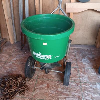 AN ASSORTMENT OF YARD TOOLS AND A SPREADER