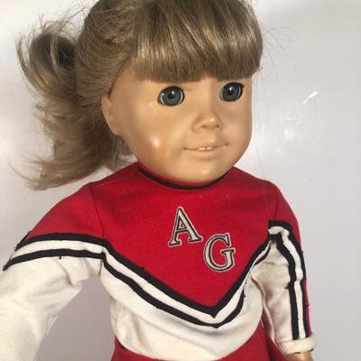 LOT 59G: American Girl Doll w/ Cheerleader Outfit, Purple Outfit w/ Denim Vest, Molly's Christmas Dress & More
