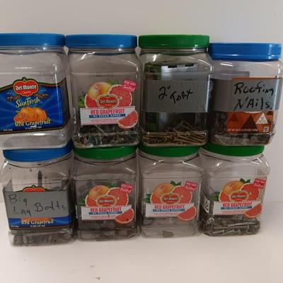8 plastic lidded containers with home hardware - bolts - screws - nails - and more