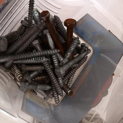 8 plastic lidded containers with home hardware - bolts - screws - nails - and more
