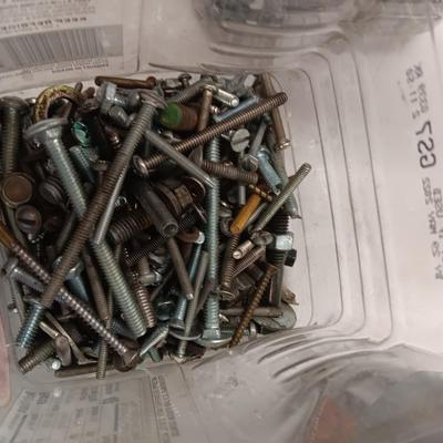 8 plastic lidded containers with home hardware - bolts - screws - nails - and more