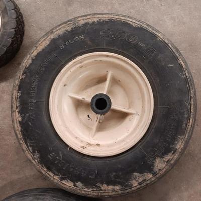 Assortment of 4 small different sized tires with rims