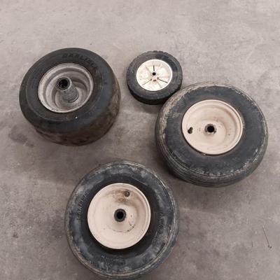 Assortment of 4 small different sized tires with rims