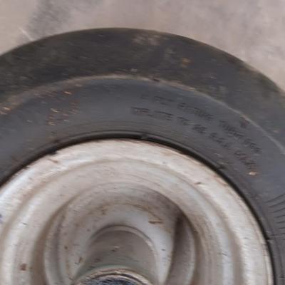 Assortment of 4 small different sized tires with rims