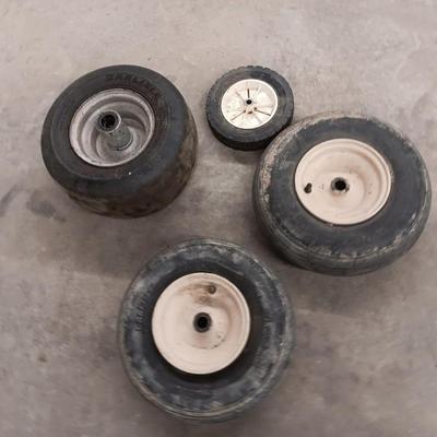 Assortment of 4 small different sized tires with rims