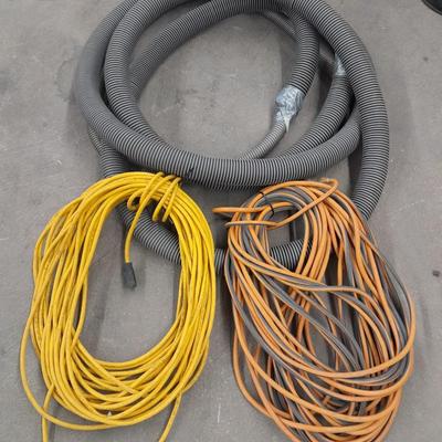 Two long outdoor extension cords and tubing extension for a shop vacuum