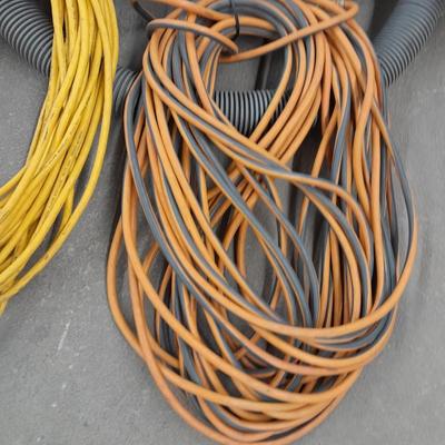 Two long outdoor extension cords and tubing extension for a shop vacuum