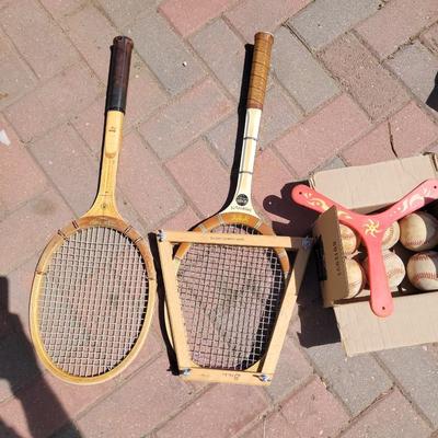 Vintage and antique tennis rackets, six baseballs and a boomerang