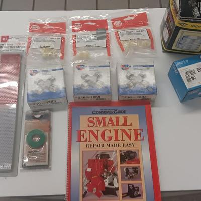 Small engine repair book with brand new car parts - U joints - Piston Ring Compressor - Trim panel retainers and more