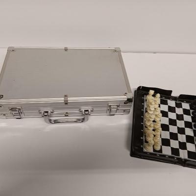Poker chips in a metal case and a chess set