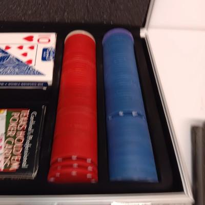 Poker chips in a metal case and a chess set