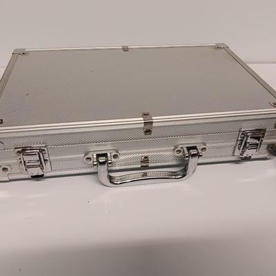 Poker chips in a metal case and a chess set
