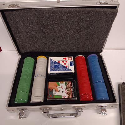 Poker chips in a metal case and a chess set