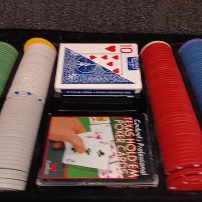 Poker chips in a metal case and a chess set