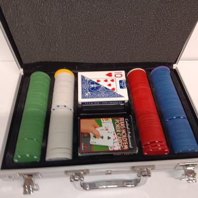 Poker chips in a metal case and a chess set