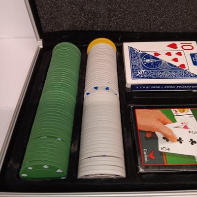 Poker chips in a metal case and a chess set