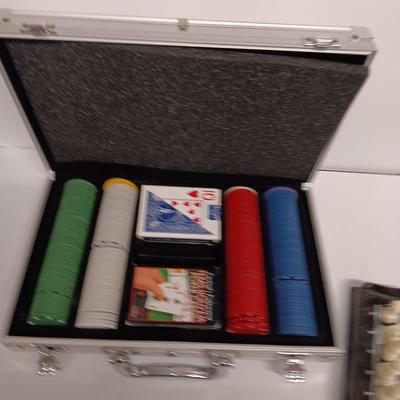 Poker chips in a metal case and a chess set