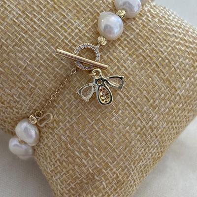Pearl and gold tone bracelet with crystals, bee charm