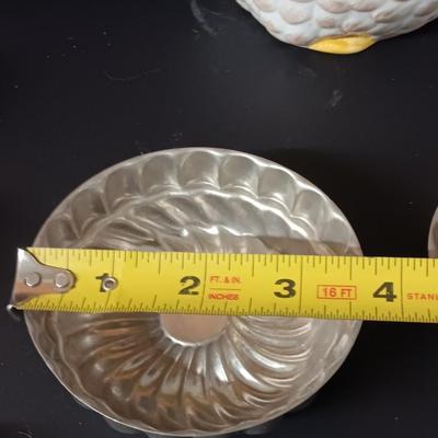 Antique aluminum Jello molds - ceramic rooster tea pot - and a decorative basket