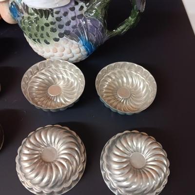 Antique aluminum Jello molds - ceramic rooster tea pot - and a decorative basket
